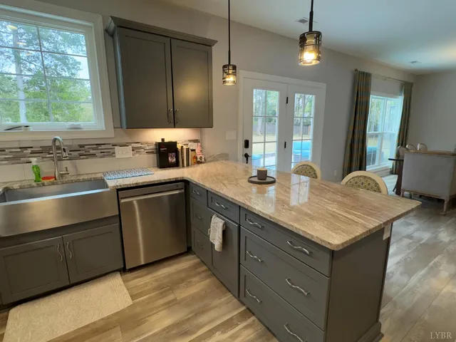 a kitchen with stainless steel appliances granite countertop a sink stove and cabinets