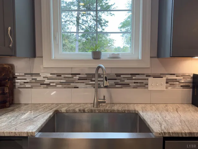 a kitchen with granite countertop a sink and a counter