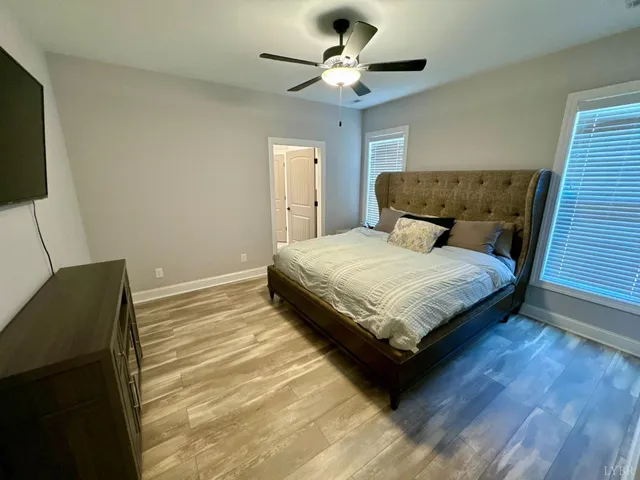 a bedroom with a bed and a ceiling fan