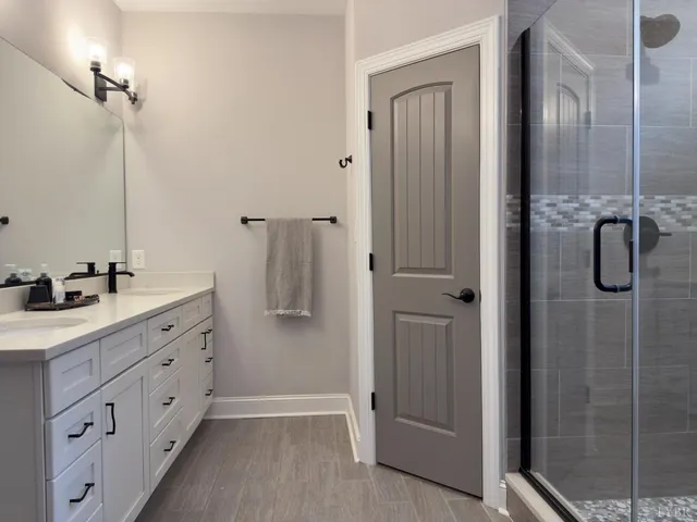 a bathroom with a double vanity sink and mirror