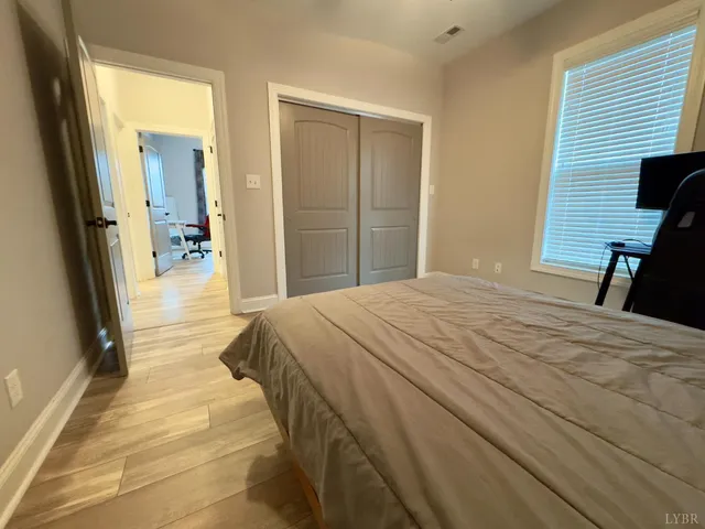 a bedroom with a bed and a large mirror