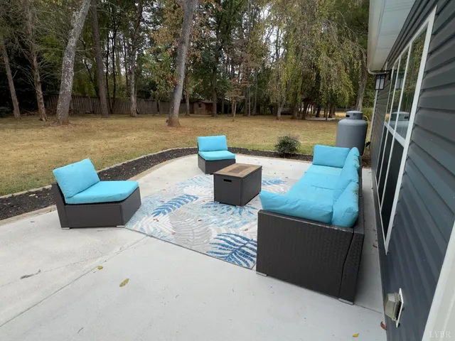 a view of a backyard with swimming pool and furniture