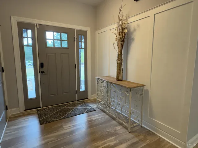 a view of a hallway with wooden floor and stairs