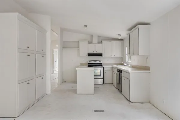 a kitchen with white cabinets and white appliances