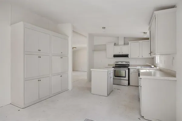 a kitchen with cabinets and appliances