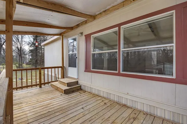a living room with wooden floor and large window