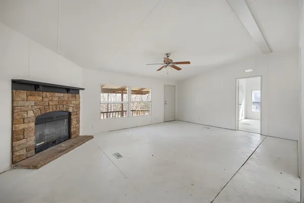 a view of empty room with windows and fireplace