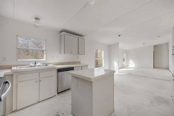 a kitchen with a sink cabinets and window