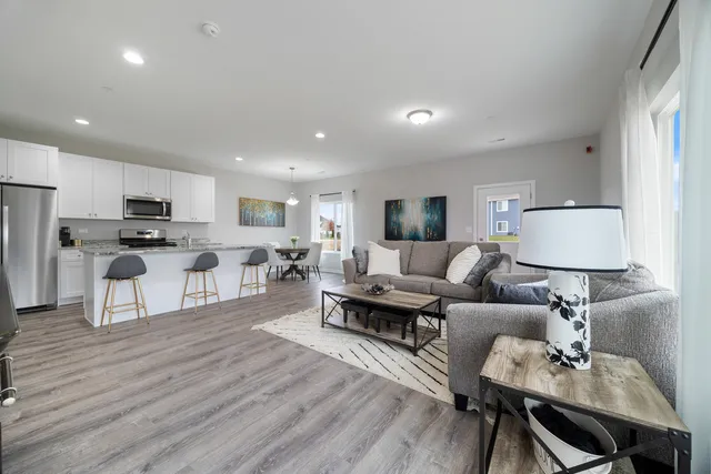 a living room with furniture and a wooden floor