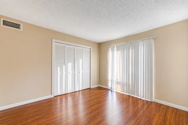 a view of wooden floor and windows in a room