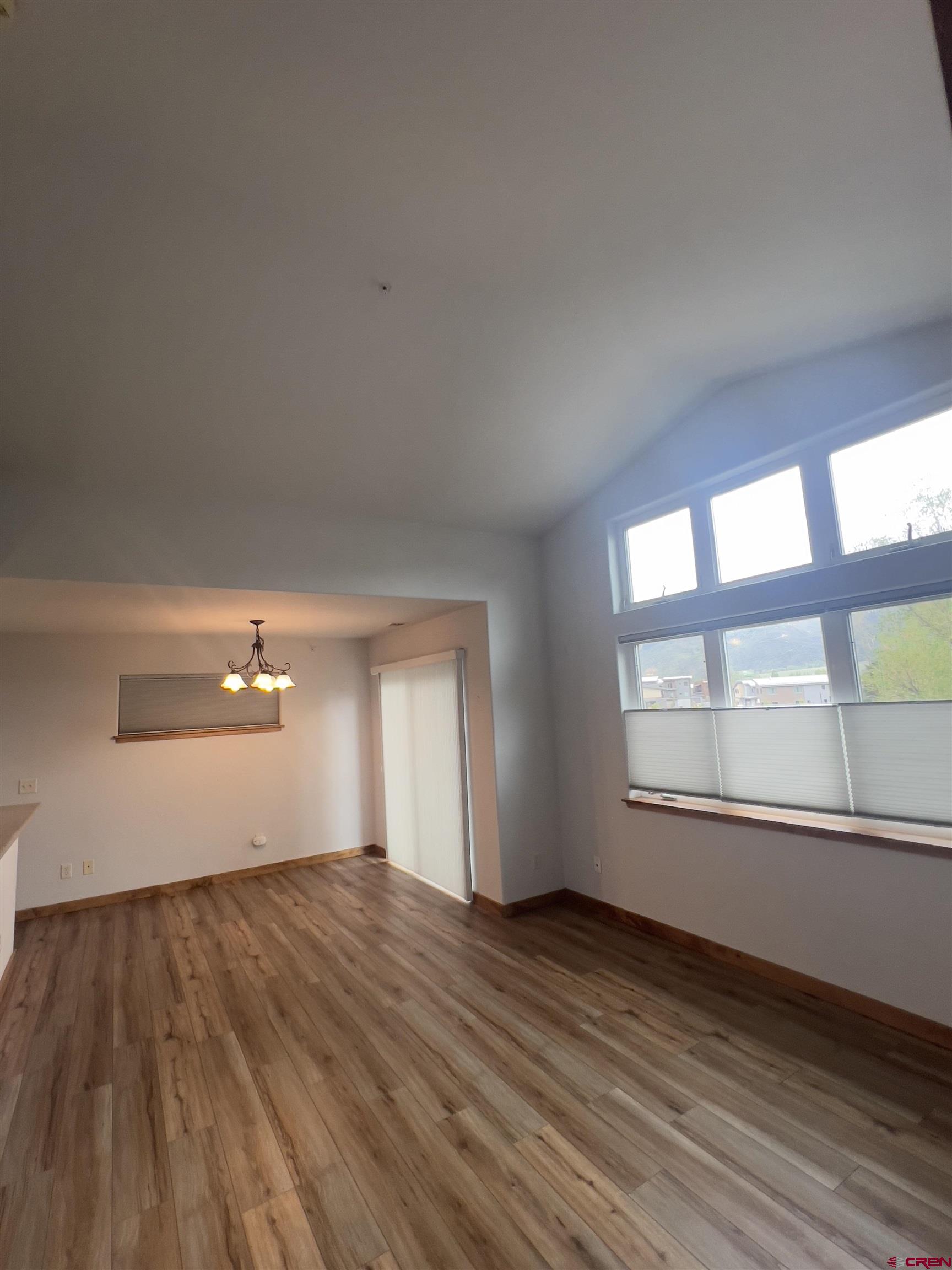 540 Redcliff Circle, Unit E 203 Ridgway, CO 81432 - Photo 17 of 36 wooden floor in an empty room with a window