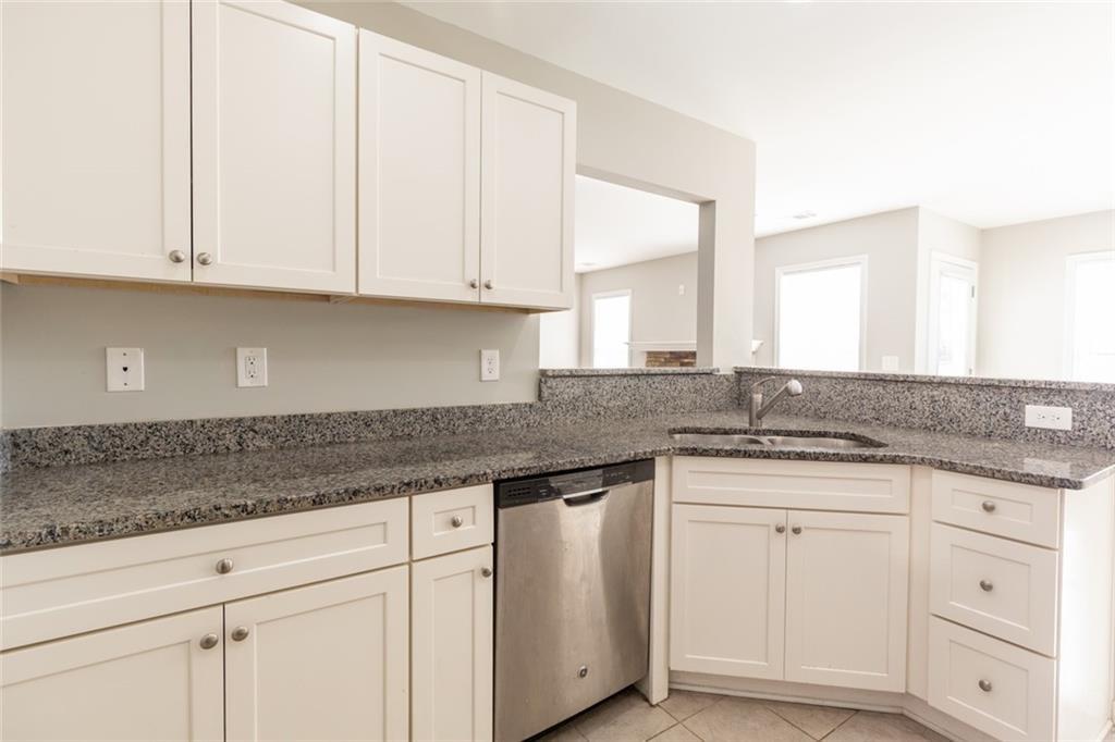 82 Gray Field Court Jefferson, GA 30549 - Photo 11 of 30 a kitchen with granite countertop white cabinets and a sink