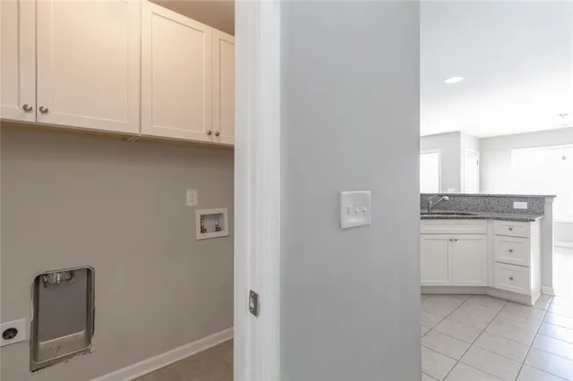 a kitchen with white cabinets and a sink