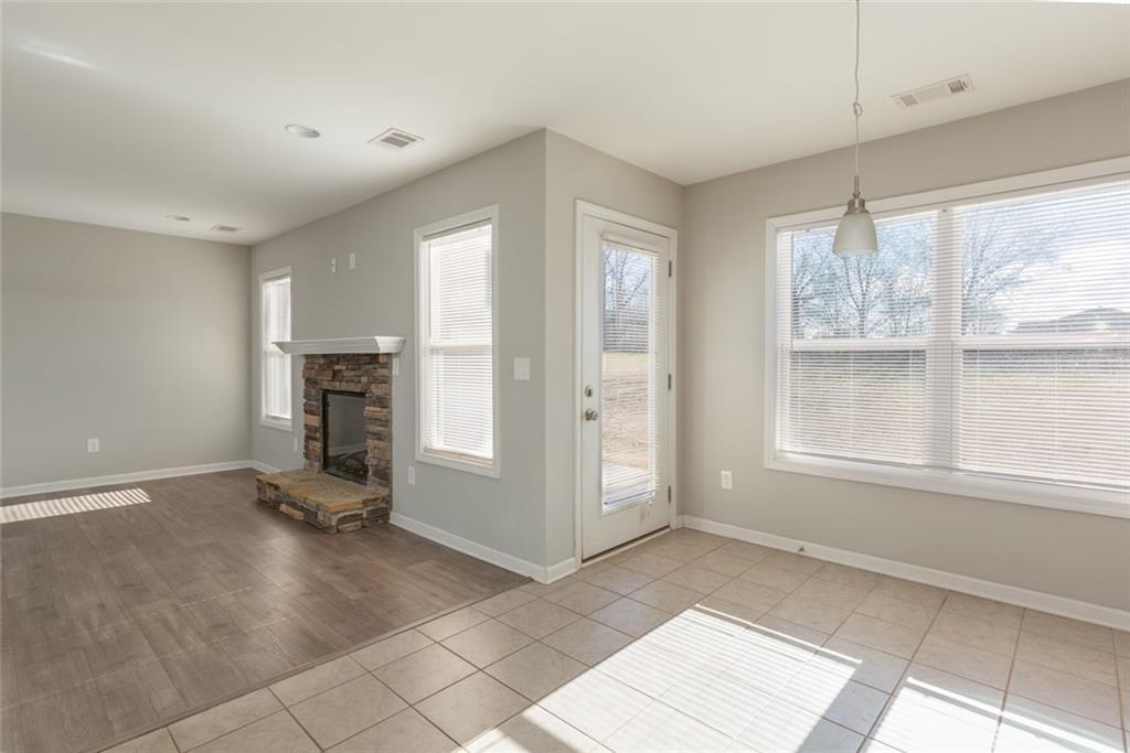 82 Gray Field Court Jefferson, GA 30549 - Photo 16 of 30 a view of empty room with a fireplace and windows