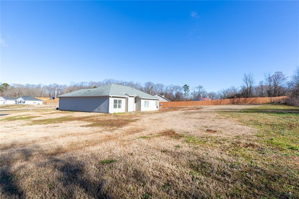 82 Gray Field Court Jefferson, GA 30549 - Photo 27 of 30 a view of a big yard with an empty space