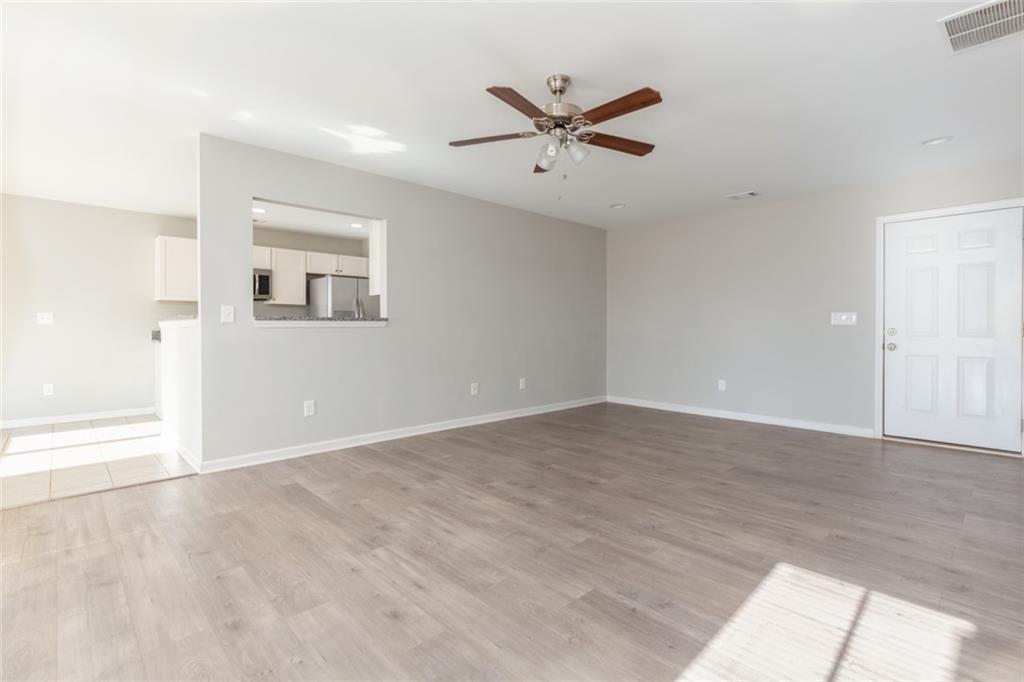 82 Gray Field Court Jefferson, GA 30549 - Photo 3 of 30 a view of a big room with wooden floor closet and windows
