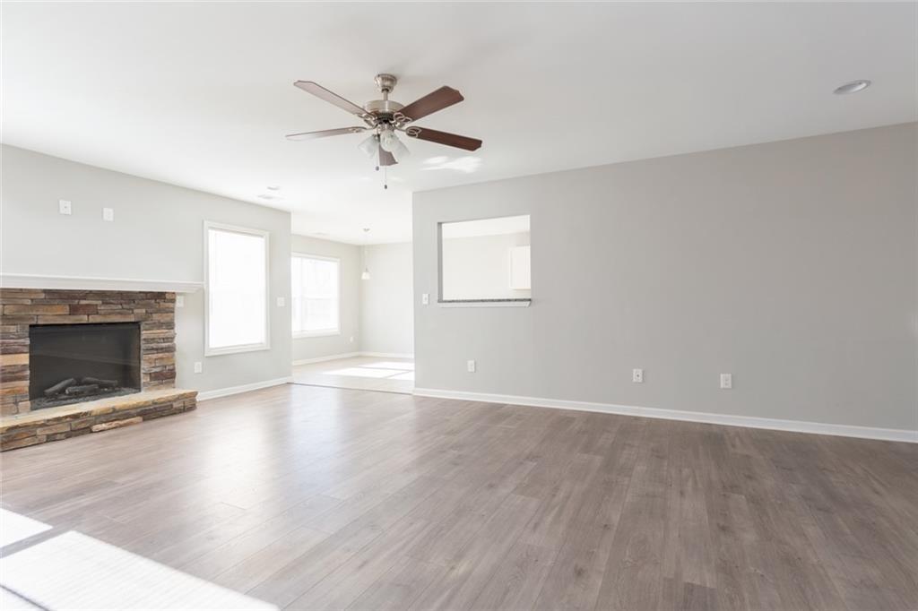 82 Gray Field Court Jefferson, GA 30549 - Photo 4 of 30 a view of an empty room with wooden floor and a window