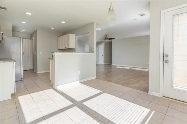 a view of a kitchen with a sink and a refrigerator
