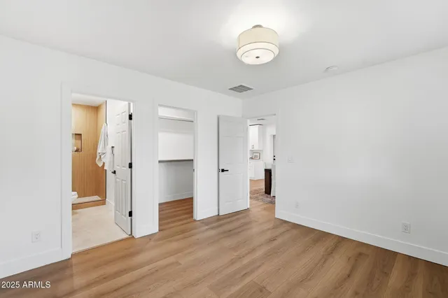 a view of a room with wooden floor