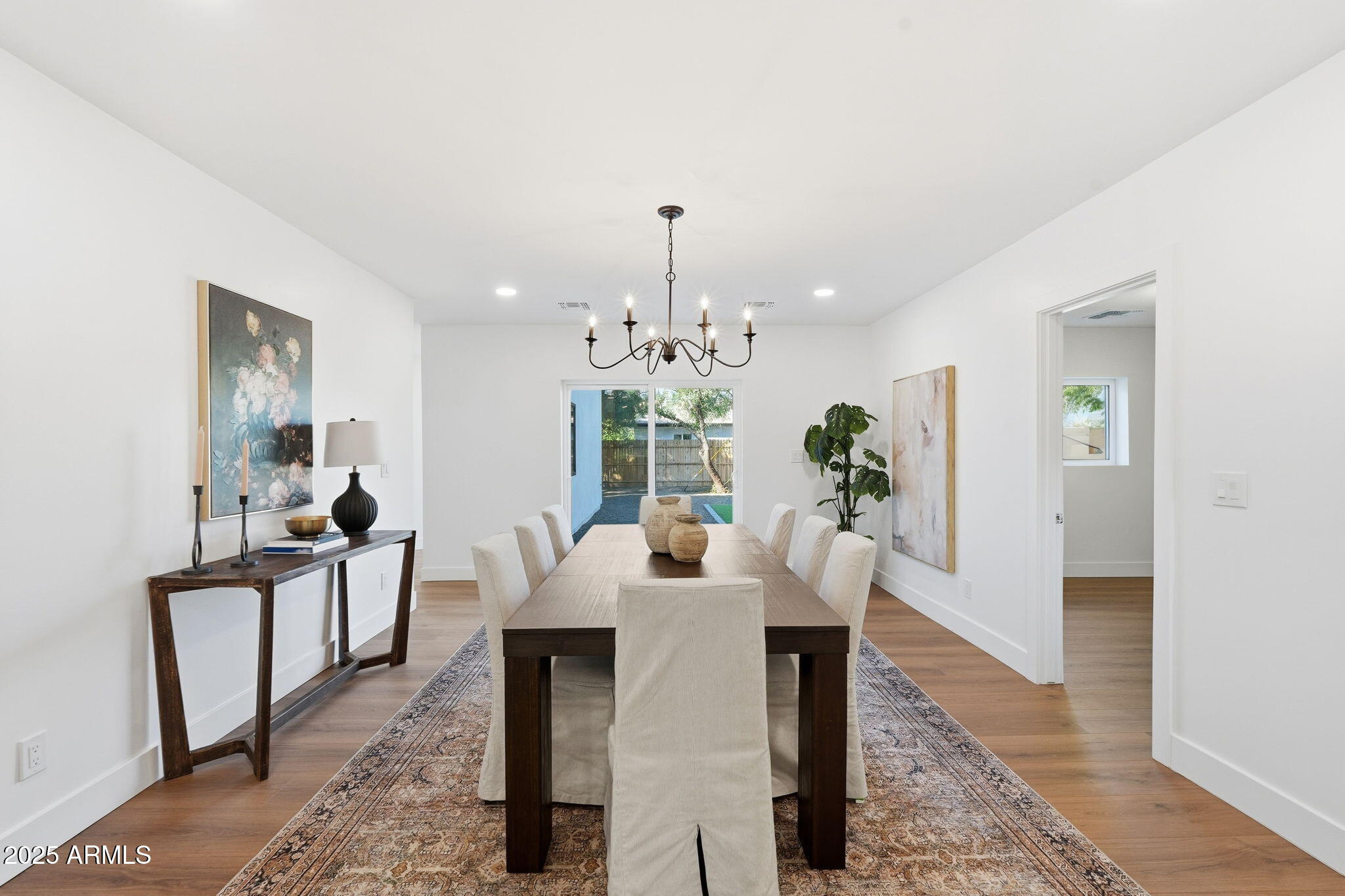 3102 North 34th Street Phoenix, AZ 85018 - Photo 10 of 20 a dining room with furniture potted plants and wooden floor