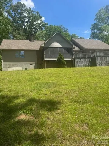 an aerial view of lake with green space