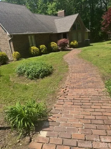 a view of a house with a yard and garage