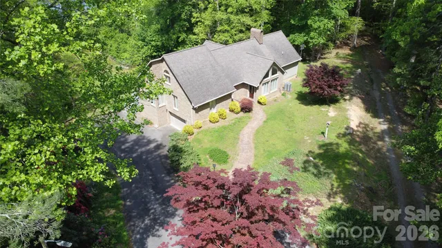 an aerial view of a house with a yard and garden