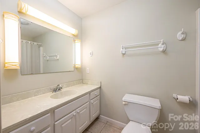 an empty room with wooden floor and a ceiling fan