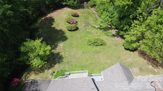 an aerial view of a houses with a lake view