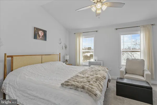 a bedroom with a large bed and a couch