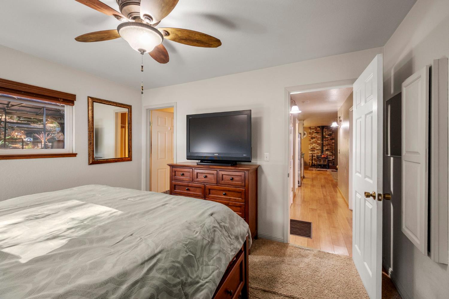 734 Utica Drive Murphys, CA 95247 - Photo 14 of 36 a bedroom with a bed and a flat screen tv