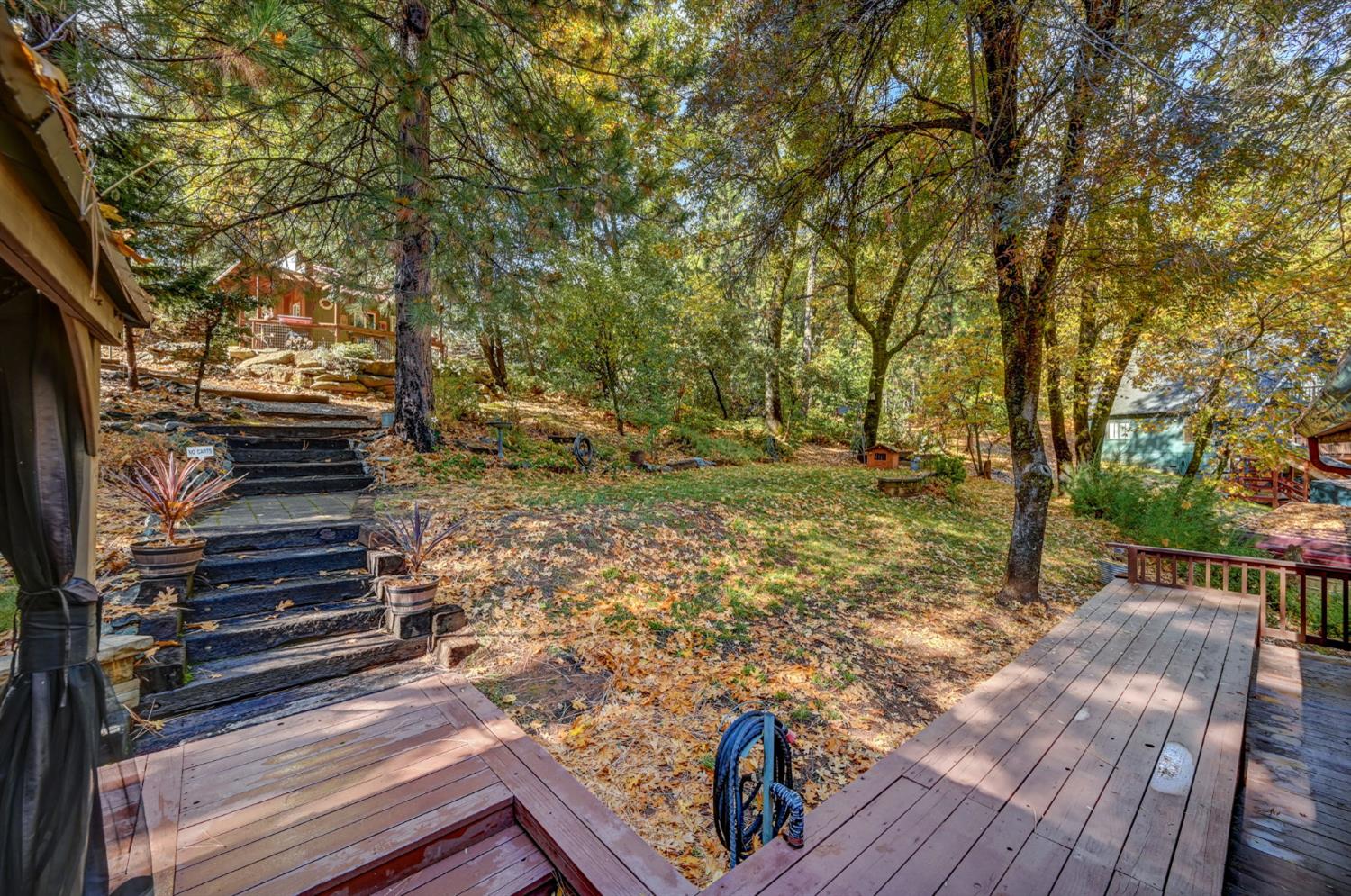 734 Utica Drive Murphys, CA 95247 - Photo 28 of 36 a view of a yard with wooden stairs and a bench