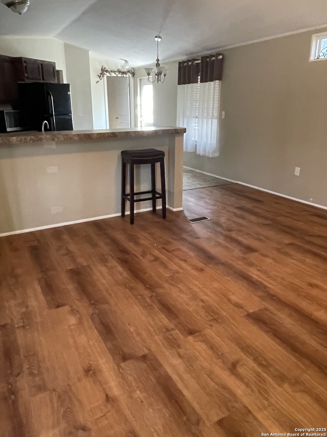 449 Mountain View Drive Bandera, TX 78003 - Photo 12 of 18 a view of an empty room with kitchen and a window