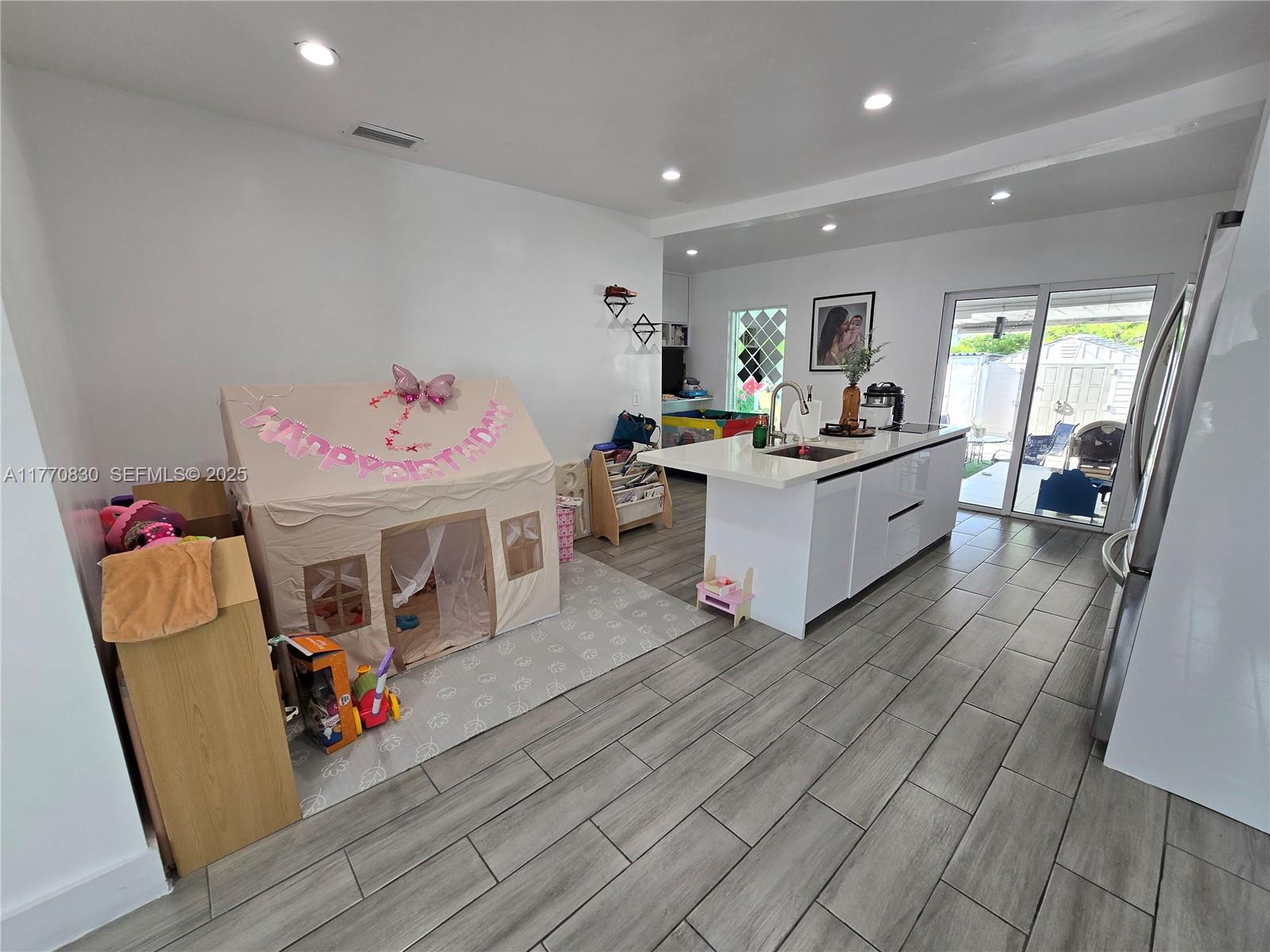 1011 Northwest 64th Street Miami, FL 33150 - Photo 13 of 48 a living room with furniture and wooden floor