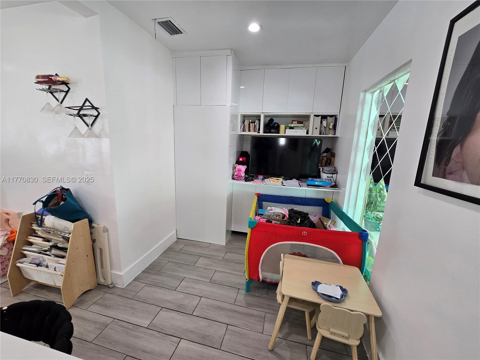 1011 Northwest 64th Street Miami, FL 33150 - Photo 15 of 48 a bedroom with a bed and a couch