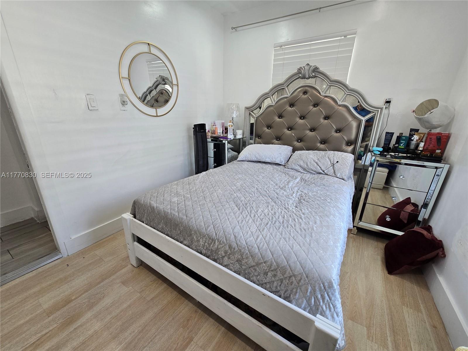 1011 Northwest 64th Street Miami, FL 33150 - Photo 18 of 48 a bedroom with a bed and a chair