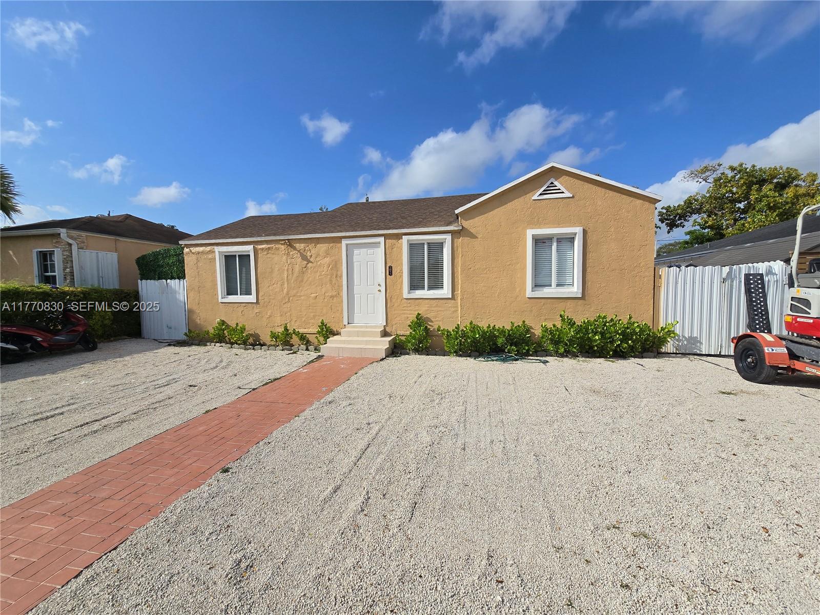 1011 Northwest 64th Street Miami, FL 33150 - Photo 2 of 48 a front view of a house with a yard