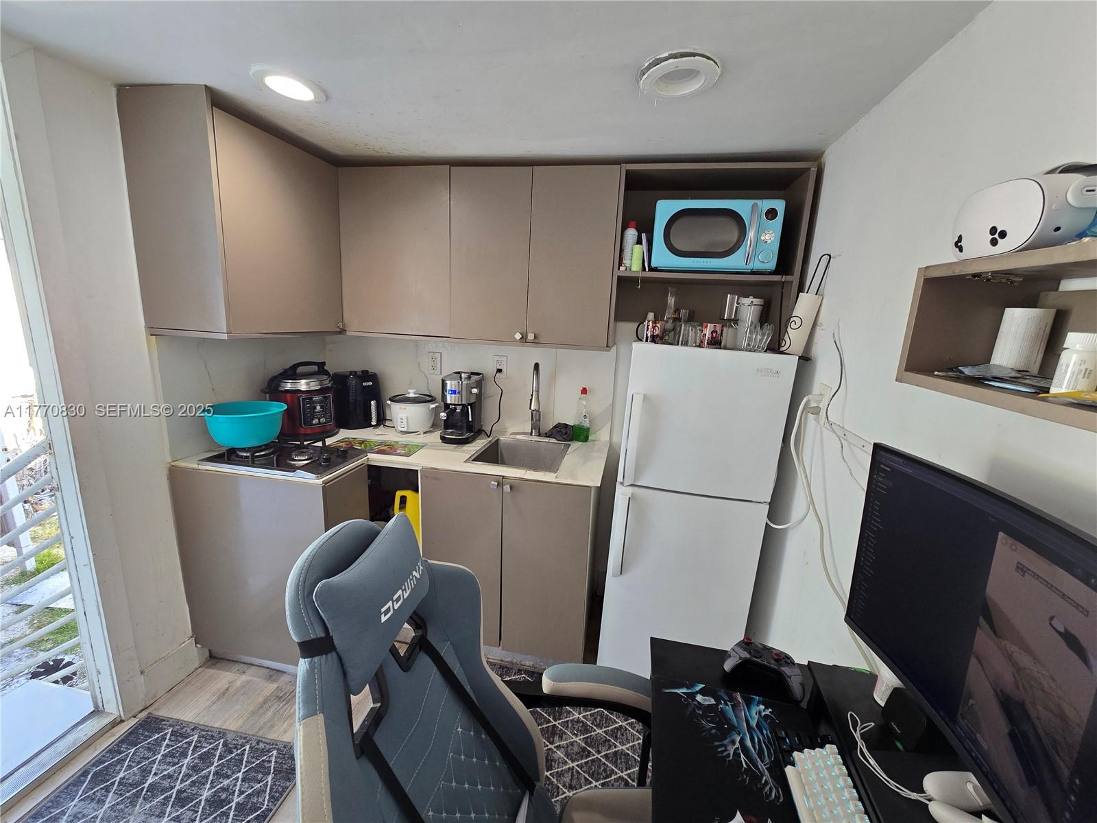 1011 Northwest 64th Street Miami, FL 33150 - Photo 47 of 48 a room with furniture a flat screen tv and rug