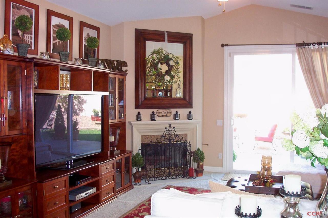 737 Onstott Road Lompoc, CA 93436 - Photo 4 of 22 a living room with furniture a flat screen tv and a fireplace