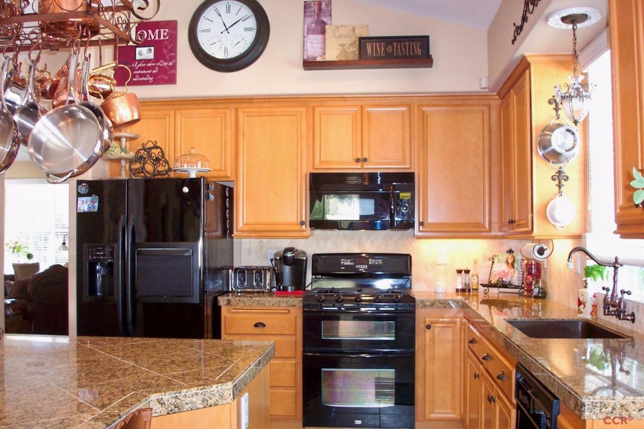 737 Onstott Road Lompoc, CA 93436 - Photo 7 of 22 a kitchen with stainless steel appliances granite countertop a stove and a refrigerator