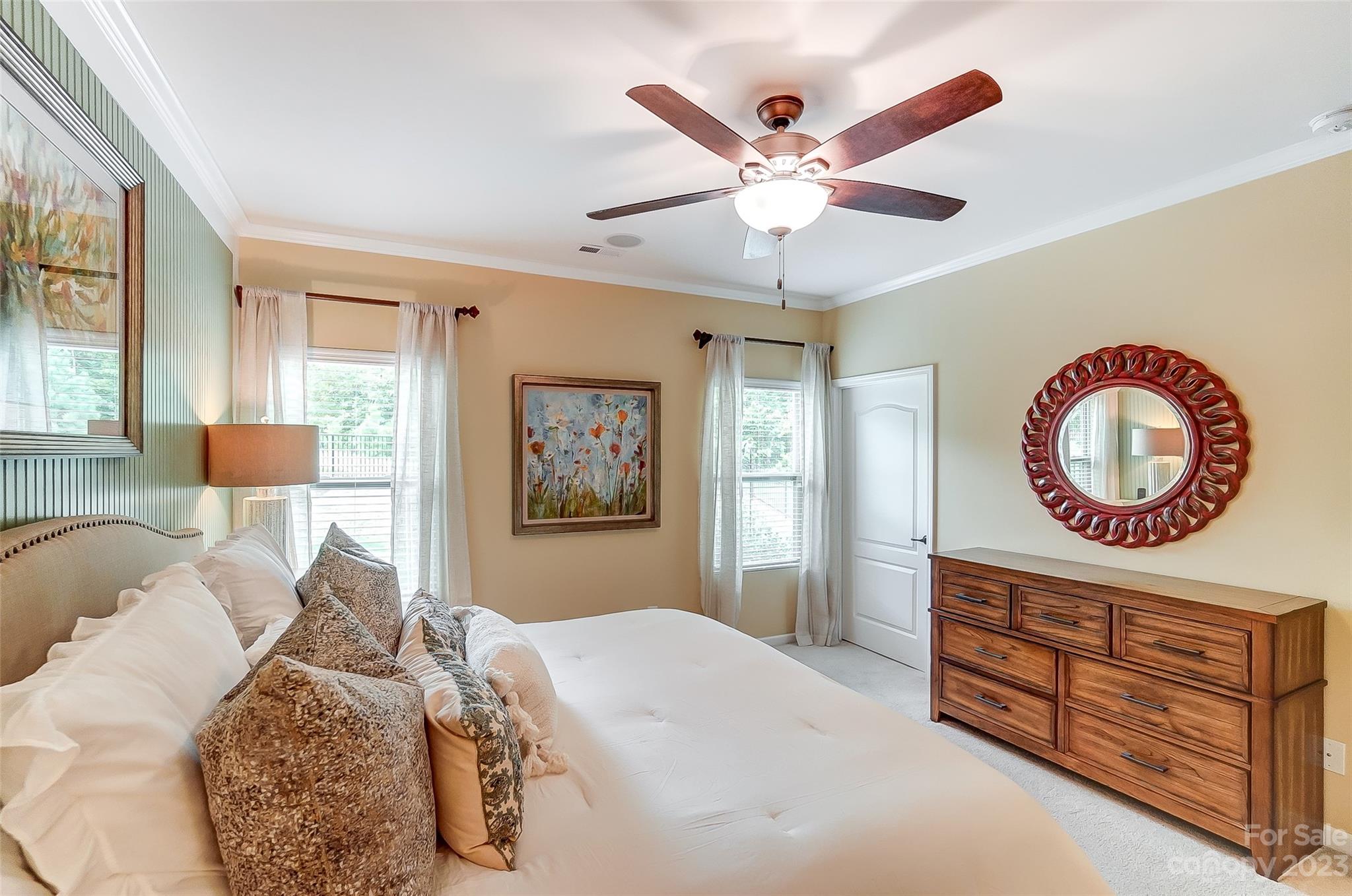 1719 Still River Way Fort Mill, SC 29708 - Photo 20 of 41 a bedroom with a bed and a chandelier