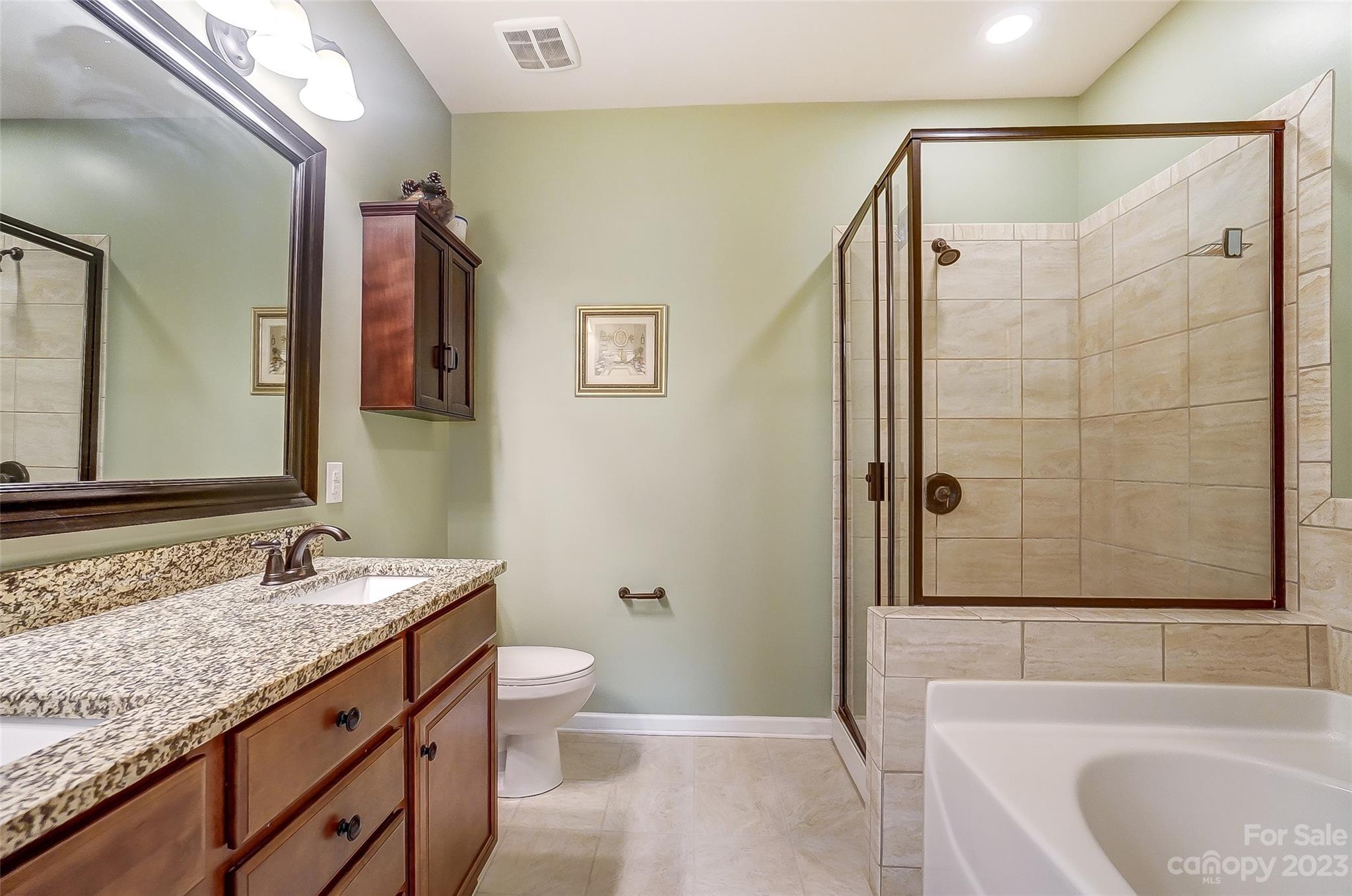 1719 Still River Way Fort Mill, SC 29708 - Photo 21 of 41 a bathroom with a granite countertop sink toilet and shower