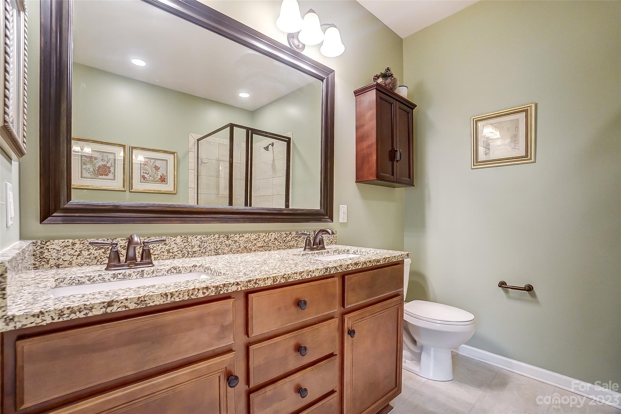 1719 Still River Way Fort Mill, SC 29708 - Photo 23 of 41 a bathroom with a granite countertop toilet sink and mirror