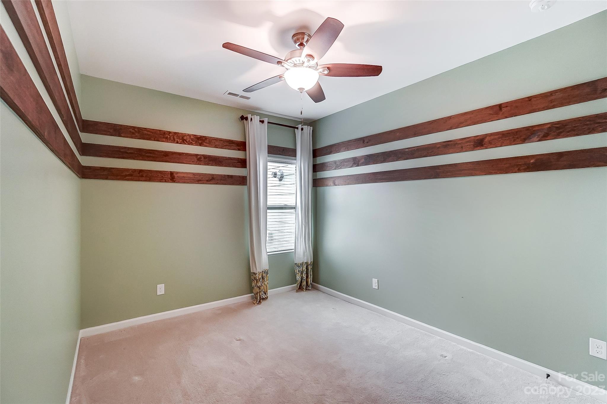 1719 Still River Way Fort Mill, SC 29708 - Photo 27 of 41 a view of a room with a ceiling fan and refrigerator