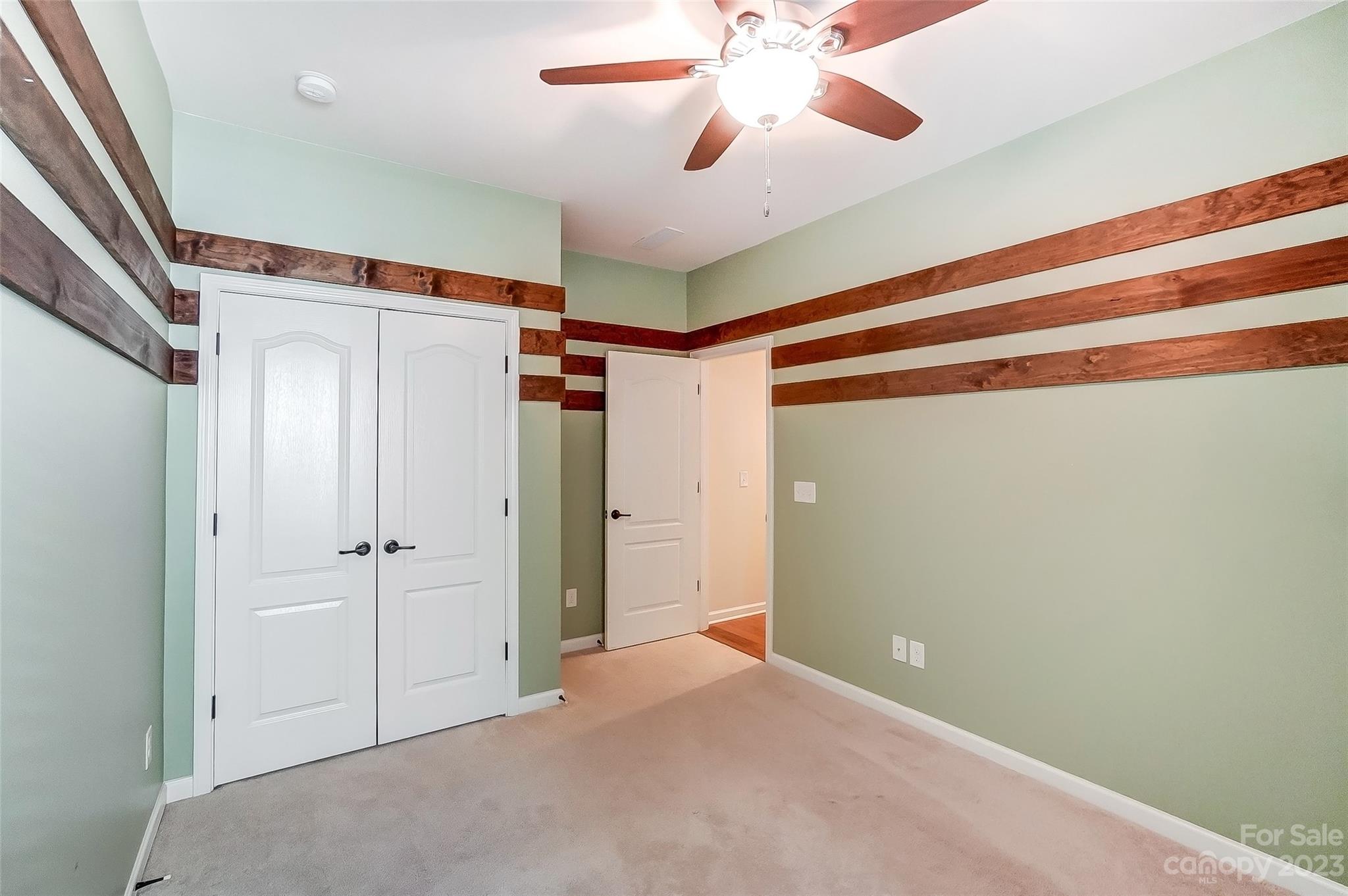1719 Still River Way Fort Mill, SC 29708 - Photo 28 of 41 a view of a hallway with a chandelier fan and wooden floor