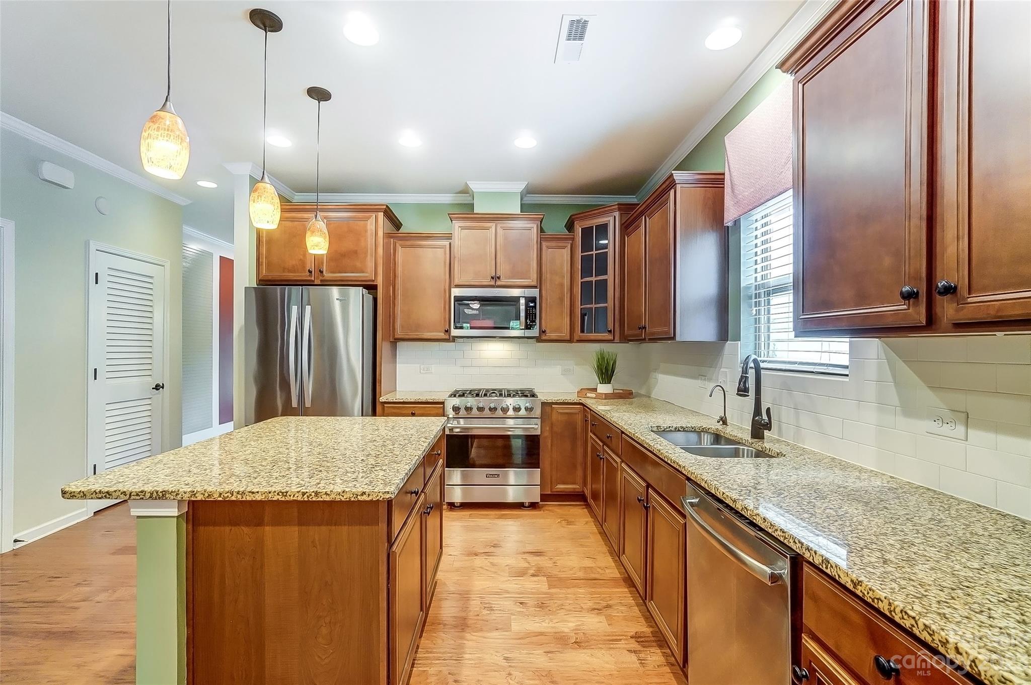 1719 Still River Way Fort Mill, SC 29708 - Photo 5 of 41 a kitchen with stainless steel appliances granite countertop a sink stove and refrigerator