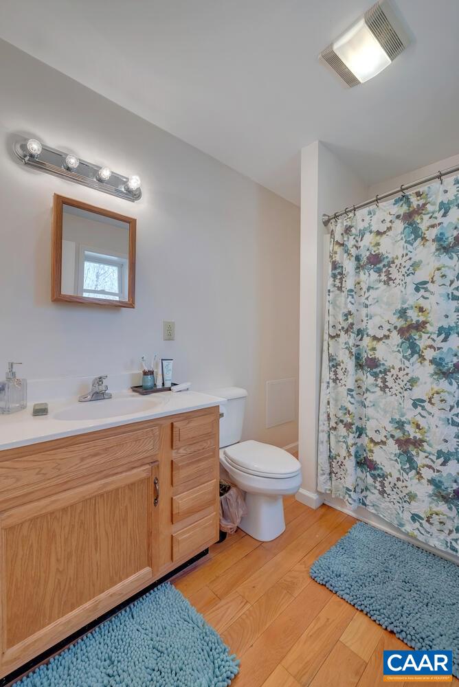 2850 Camp Spring Road Esmont, VA 22937 - Photo 15 of 35 a bathroom with a toilet sink and mirror