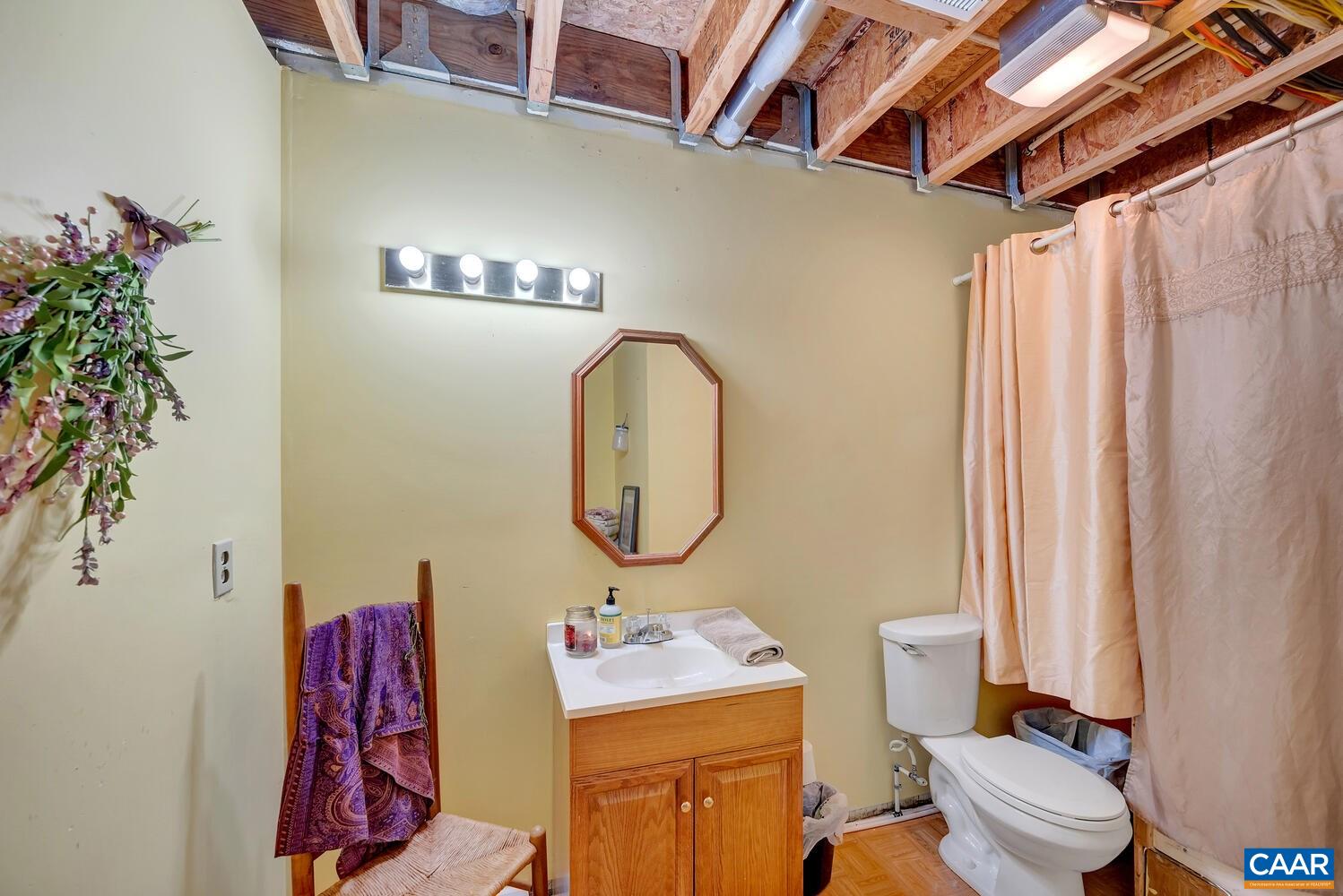 2850 Camp Spring Road Esmont, VA 22937 - Photo 24 of 35 a bathroom with a toilet sink vanity tub and mirror