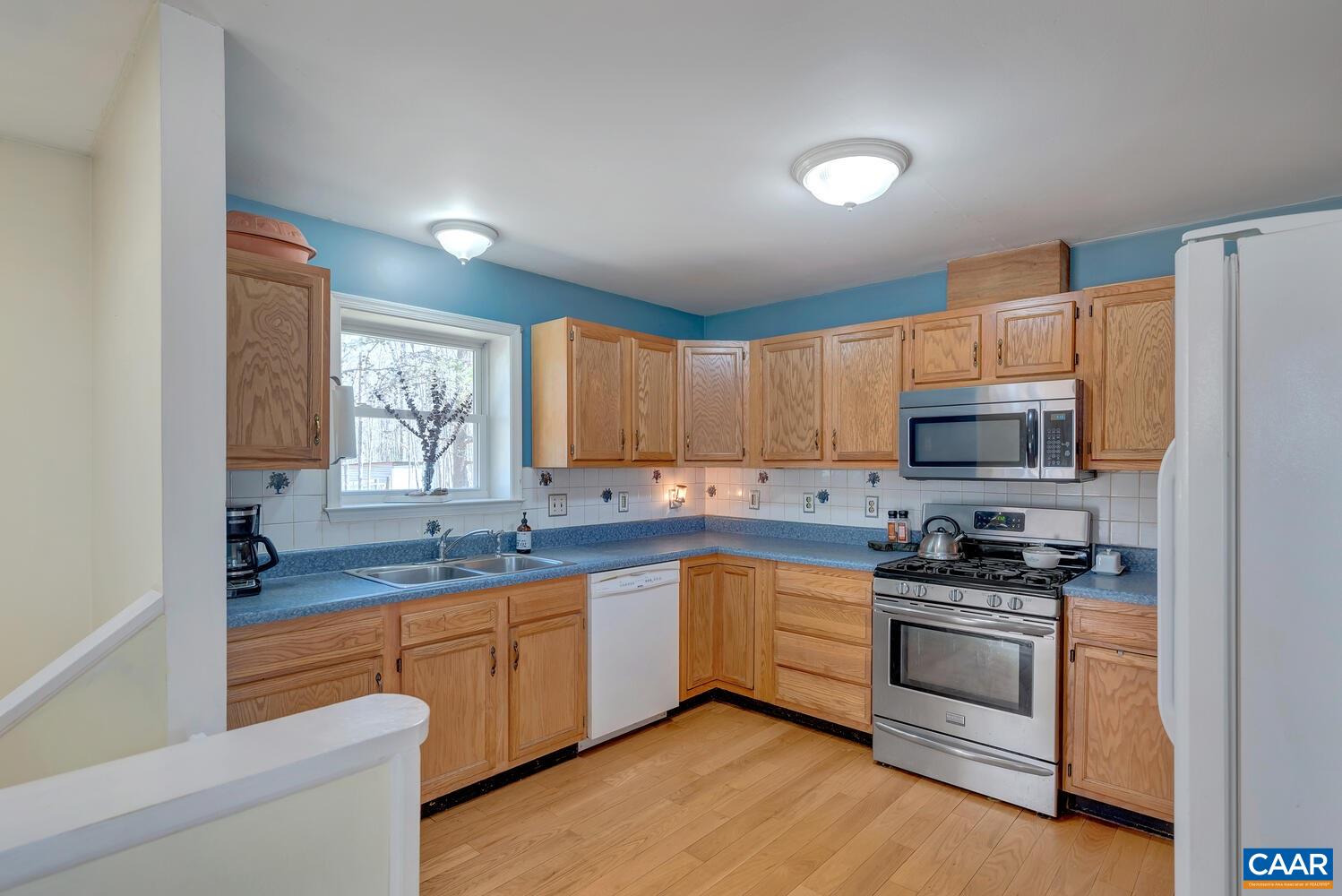 2850 Camp Spring Road Esmont, VA 22937 - Photo 9 of 35 a kitchen with granite countertop a sink stainless steel appliances and cabinets