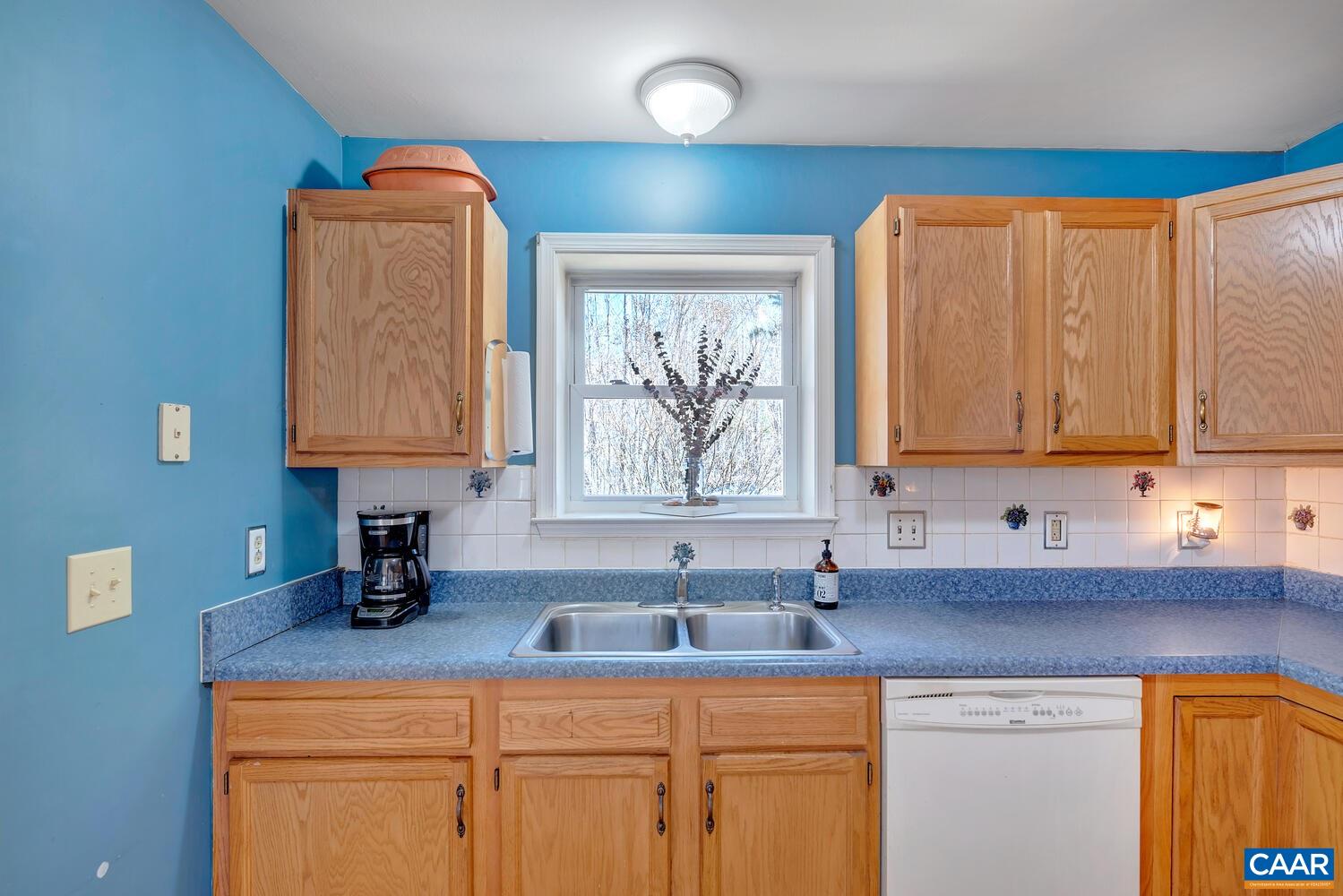 2850 Camp Spring Road Esmont, VA 22937 - Photo 10 of 35 a kitchen with sink a window and cabinets